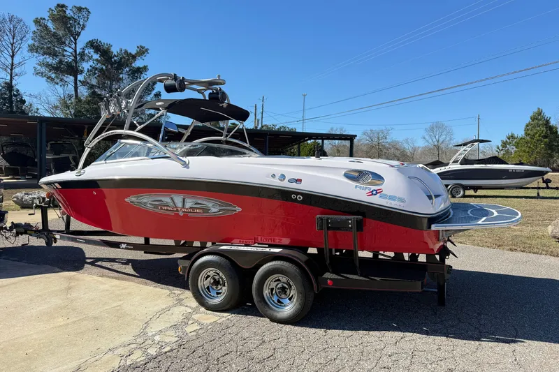 Slide: The Image of 2004 Nautique Air Nautique 226 boat with red and white design on a trailer. - 4