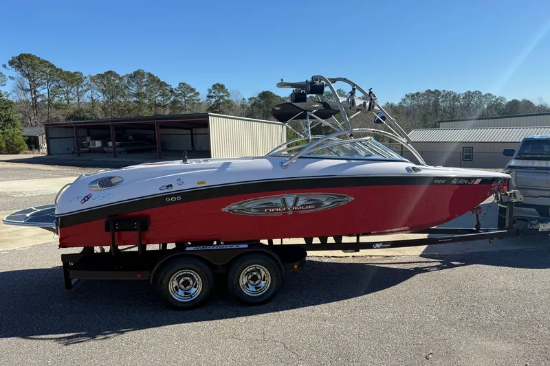 Slide: The Image of 2004 Nautique Air Nautique 226 boat on trailer, red and white design, parked outdoors. - 8