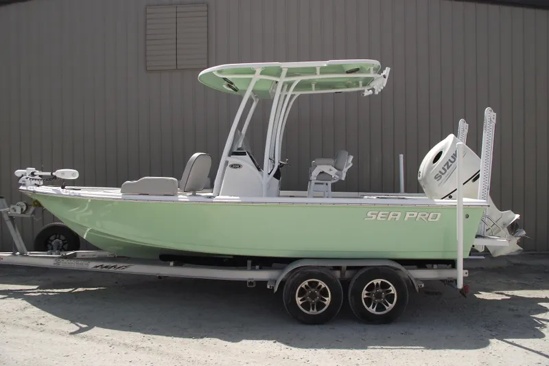 The Image of 2019 Sea Pro 208 Bay boat on trailer, light green hull, Suzuki outboard motor. - 0