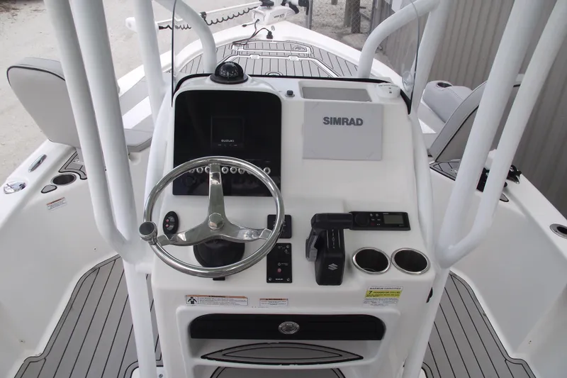 Slide: The Image of 2019 Sea Pro 208 Bay boat console with steering wheel and Simrad display. - 21