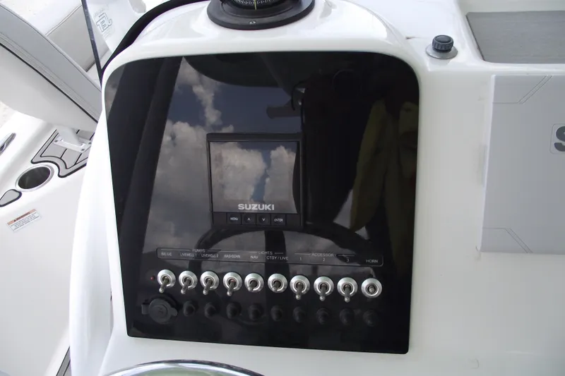 Slide: The Image of 2019 Sea Pro 208 Bay boat dashboard with Suzuki controls and switches. - 22