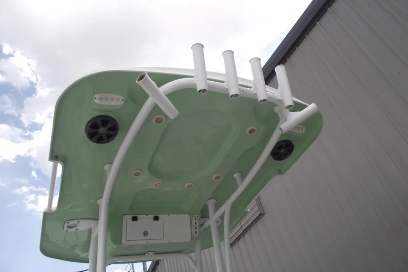 Slide: The Image of 2019 Sea Pro 208 Bay boat's T-top with rod holders and speakers, viewed from below. - 25