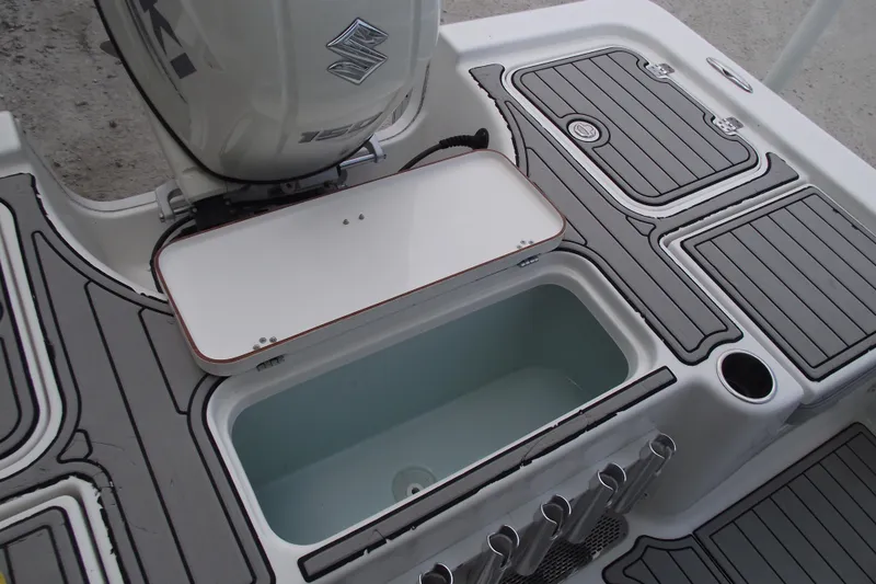 Slide: The Image of 2019 Sea Pro 208 Bay boat deck with open storage compartment and Suzuki engine. - 37