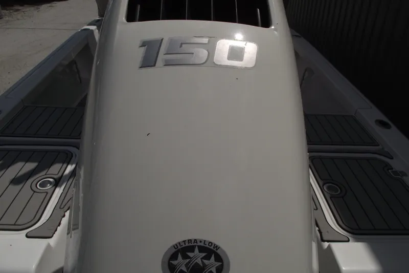 Slide: The Image of 2019 Sea Pro 208 Bay boat engine cover with "150" marking and Ultra-Low emblem. - 5