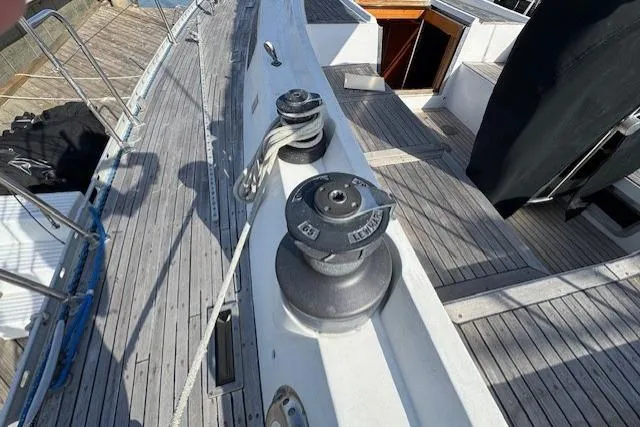 Slide: The Image of Deck of 1983 Tayana 55 sailboat with a metal pulley system. - 10