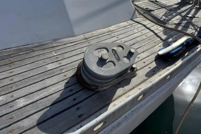 Slide: The Image of Deck of 1983 Tayana 55 sailboat with blue rope and cleat. - 11