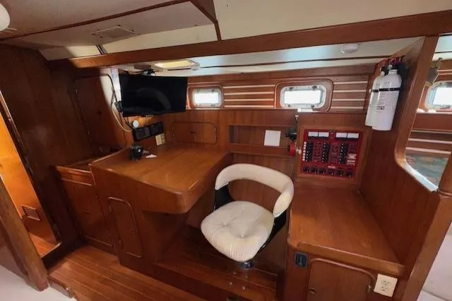 Slide: The Image of Interior of 1983 Tayana 55 yacht with wooden furnishings and cozy seating area. - 17