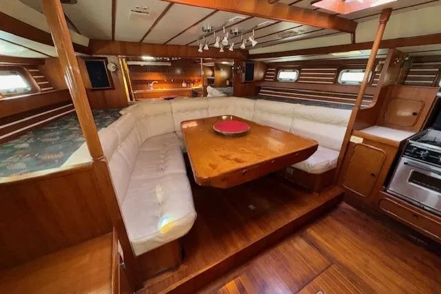 Slide: The Image of Interior of 1983 Tayana 55 yacht with wooden cabinetry and dual sinks in the galley. - 18