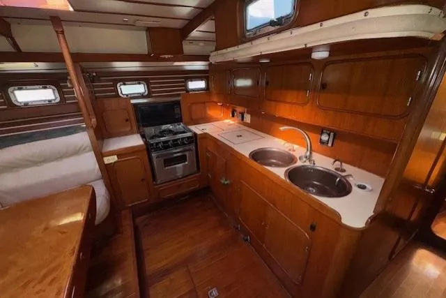 Slide: The Image of Galley kitchen in 1983 Tayana 55 yacht with stove and microwave. - 19