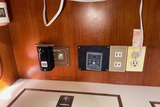 Slide: The Image of Cozy cabin interior of 1983 Tayana 55 sailboat with wooden paneling and patterned cushions. - 21