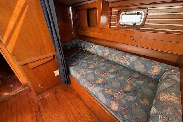 Slide: The Image of Cozy cabin interior of 1983 Tayana 55 sailboat with wooden finish and patterned cushions. - 22