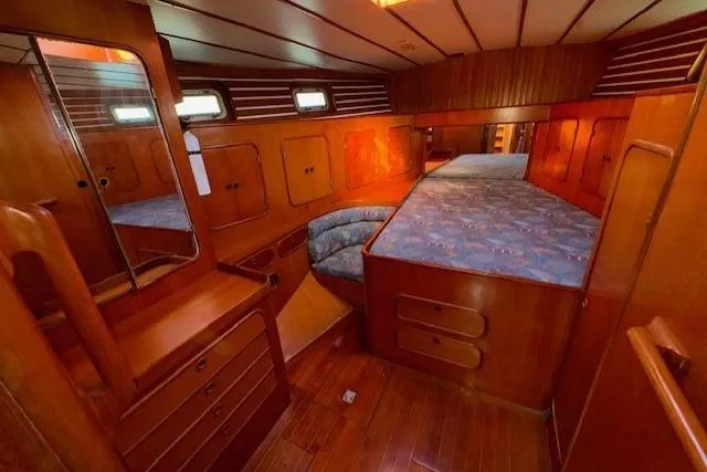 Slide: The Image of Interior of 1983 Tayana 55 yacht with wooden cabinetry and nautical decor. - 26