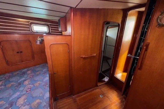 Slide: The Image of Bathroom interior of 1983 Tayana 55 yacht with sink, toilet, and storage cabinets. - 28