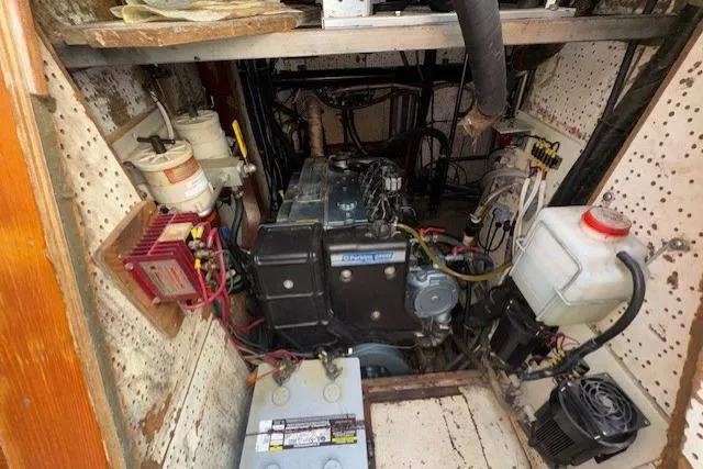 Slide: The Image of Narrow engine room of 1983 Tayana 55 yacht with storage and piping. - 31