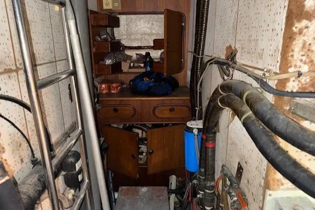 Slide: The Image of Cockpit view of 1983 Tayana 55 sailboat with steering wheel and navigation equipment. - 32