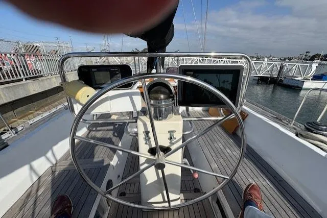 Slide: The Image of Engine compartment of a 1983 Tayana 55 sailboat, showing machinery and hoses. - 33