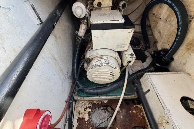 Slide: The Image of Engine room of 1983 Tayana 55 sailboat with visible machinery and components. - 34
