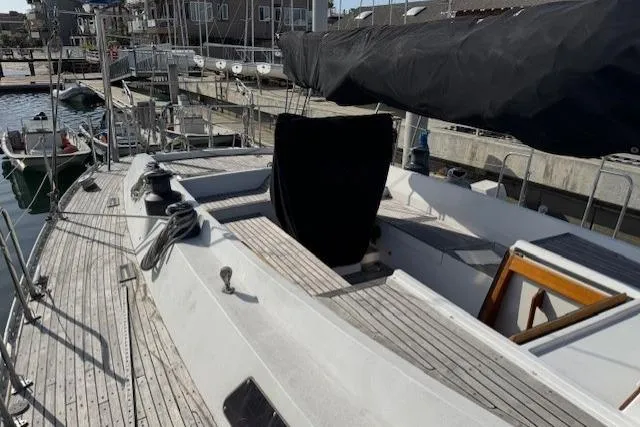 Slide: The Image of 1983 Tayana 55 sailboat docked in a marina with other boats. - 6