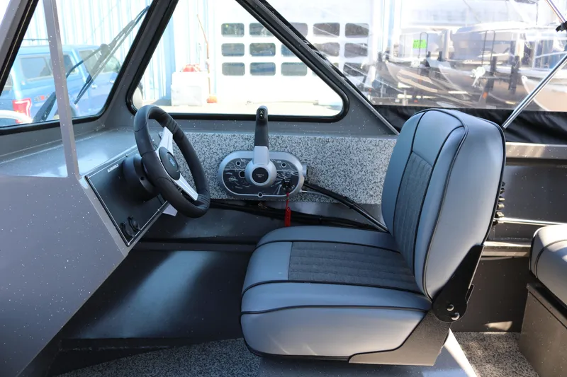 Slide: The Image of Interior of 2026 Alumaweld Talon 18 boat, featuring steering wheel and seat. - 12