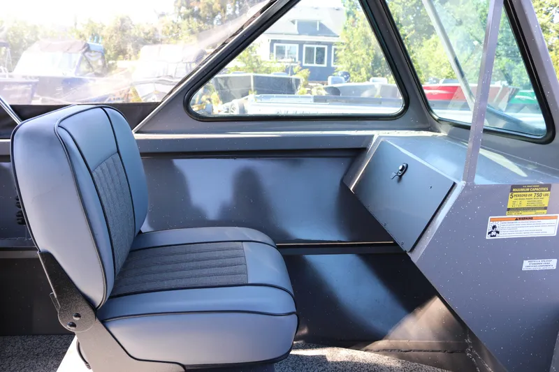 Slide: The Image of Interior of 2026 Alumaweld Talon 18 boat with gray seating and window view. - 13