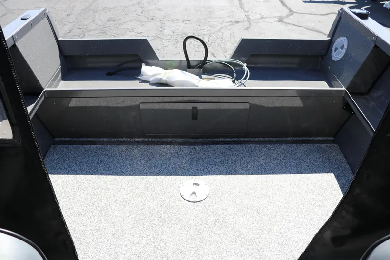 Slide: The Image of 2026 Alumaweld Talon 18 boat interior with gray flooring and storage compartment. - 14