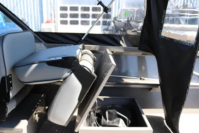 Slide: The Image of 2026 Alumaweld Talon 18 boat interior with foldable seat and storage compartment. - 17