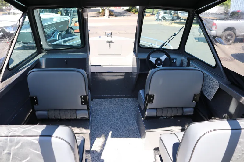 Slide: The Image of Interior of 2026 Alumaweld Talon 18 boat with seating and steering wheel. - 2