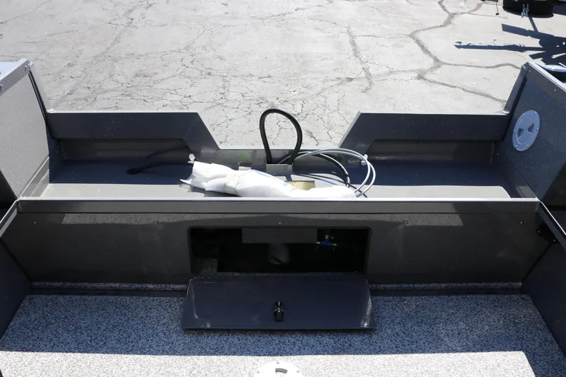 Slide: The Image of 2026 Alumaweld Talon 18 boat interior with storage compartment and wiring visible. - 21