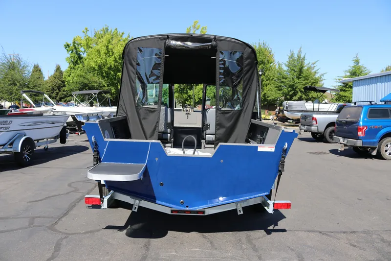 Slide: The Image of 2026 Alumaweld Talon 18 boat, blue exterior, parked outdoors with canopy. - 25