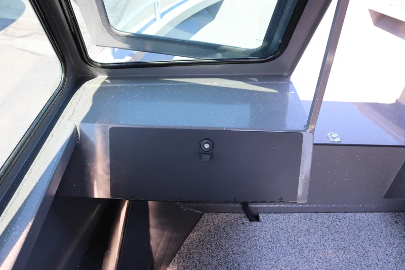 Slide: The Image of Interior view of 2026 Alumaweld Talon 18 boat dashboard with storage compartment. - 6