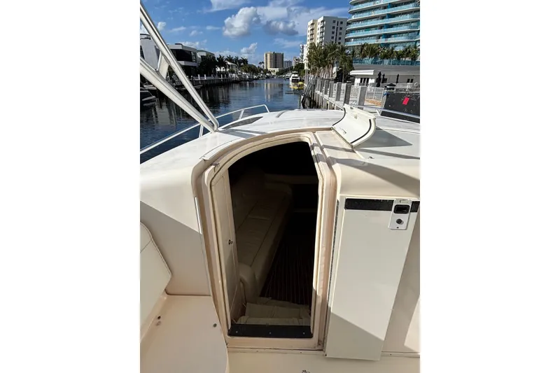 Slide: The Image of 2001 Intrepid 377 Walkaround boat cabin entrance with waterfront view. - 20