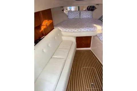 Slide: The Image of 2001 Intrepid 377 Walkaround cabin with white seating and wood accents. - 22