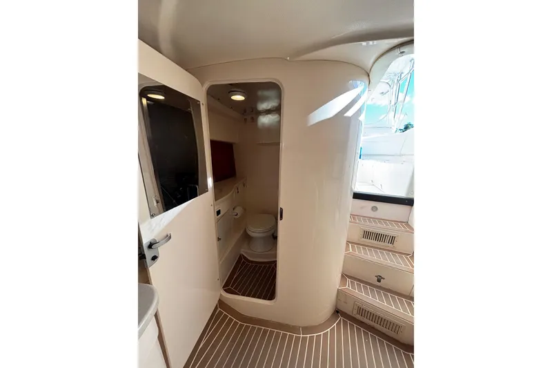 Slide: The Image of 2001 Intrepid 377 Walkaround boat interior with bathroom and wooden flooring. - 26