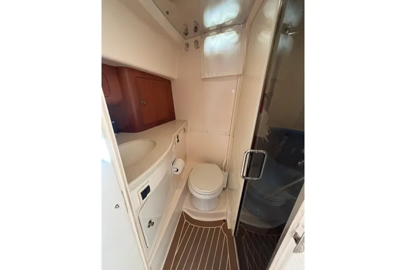 Slide: The Image of 2001 Intrepid 377 Walkaround boat bathroom with sink, toilet, and shower. - 27