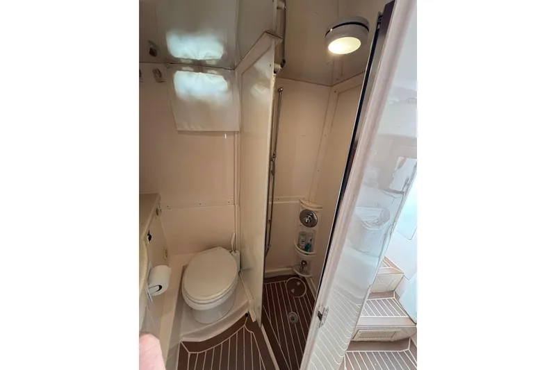 Slide: The Image of 2001 Intrepid 377 Walkaround boat bathroom with toilet and shower area. - 28