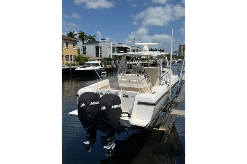 Slide: The Image of 2001 Intrepid 377 Walkaround boat docked with dual Mercury engines. - 29