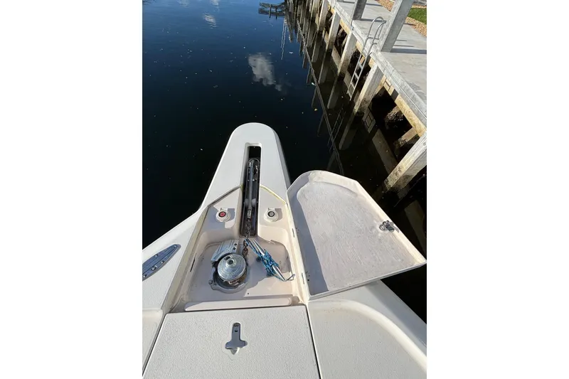 Slide: The Image of Bow view of 2001 Intrepid 377 Walkaround boat docked by the water. - 33