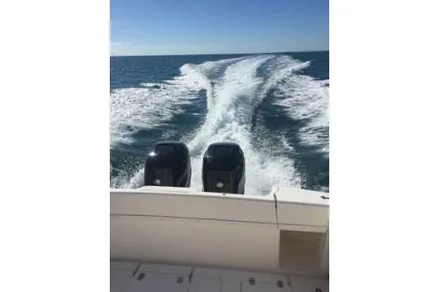 Slide: The Image of 2001 Intrepid 377 Walkaround boat cruising on open water, leaving a wake behind. - 43