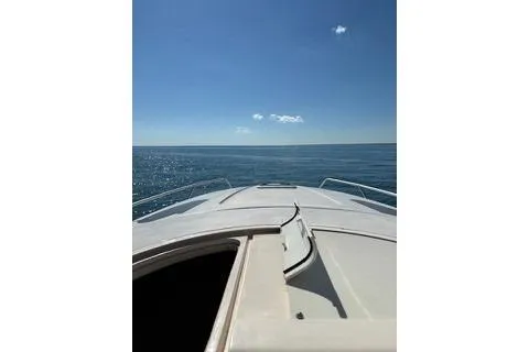 Slide: The Image of 2001 Intrepid 377 Walkaround boat cruising on open sea under clear blue sky. - 6
