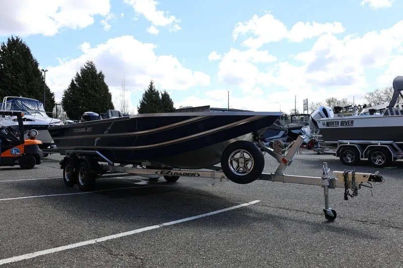 Slide: The Image of 2026 Thunder Jet 209 Rush OT boat on trailer in parking lot. - 10
