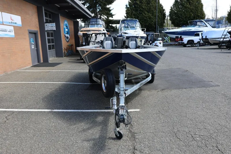 Slide: The Image of 2026 Thunder Jet 209 Rush OT boat on trailer in parking lot. - 11