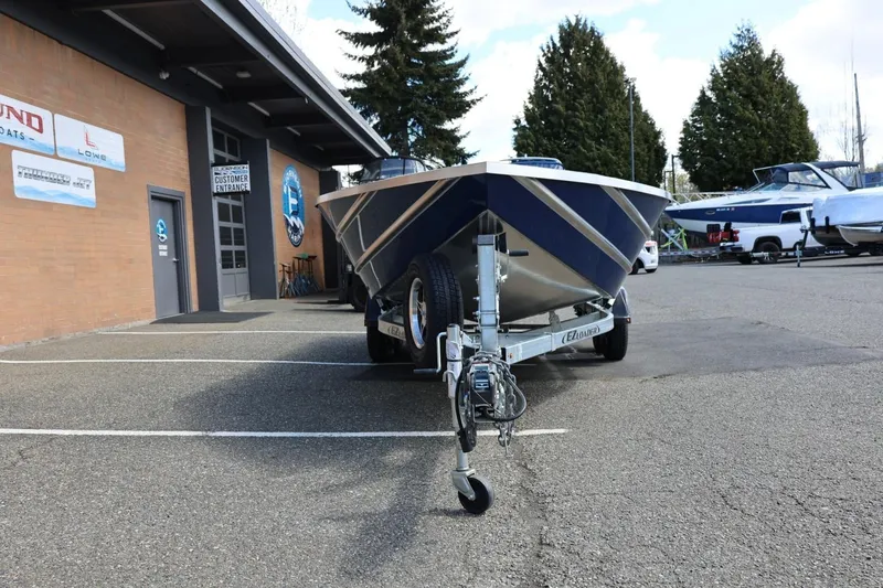 Slide: The Image of 2026 Thunder Jet 209 Rush OT boat on trailer outside dealership. - 12