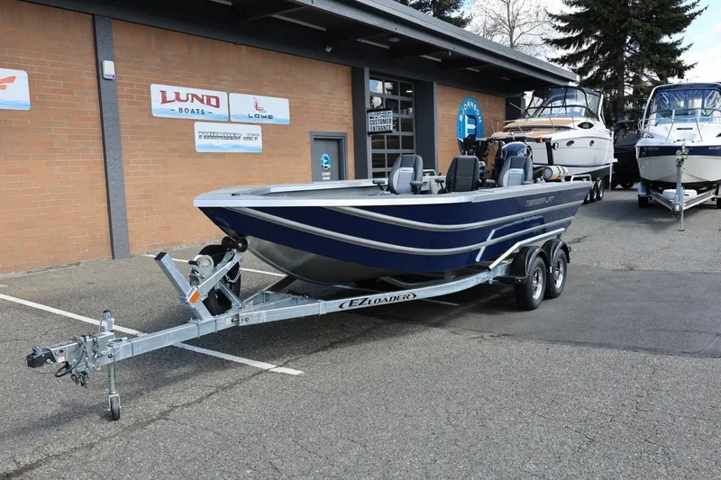 Slide: The Image of 2026 Thunder Jet 209 Rush OT boat on trailer outside dealership. - 13