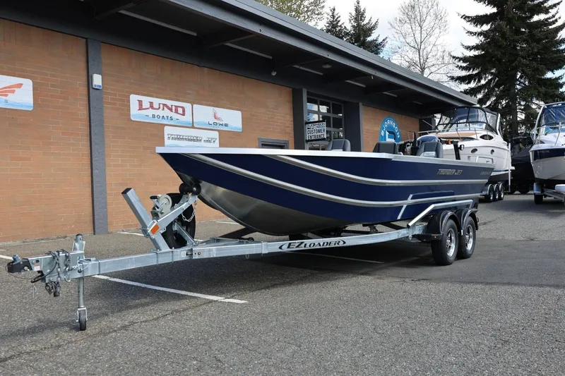 Slide: The Image of 2026 Thunder Jet 209 Rush OT boat on trailer outside dealership. - 14