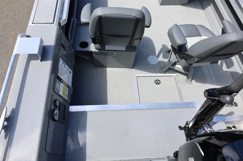 Slide: The Image of 2026 Thunder Jet 209 Rush OT boat interior with gray seating and storage compartments. - 19