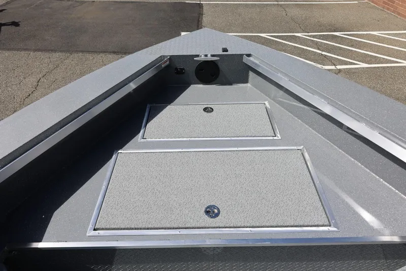 Slide: The Image of 2026 Thunder Jet 209 Rush OT boat deck with storage compartments in a parking lot. - 22