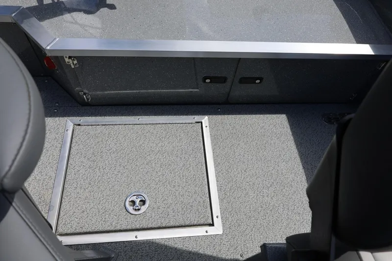 Slide: The Image of Interior view of 2026 Thunder Jet 209 Rush OT boat, featuring a carpeted floor and storage hatch. - 34