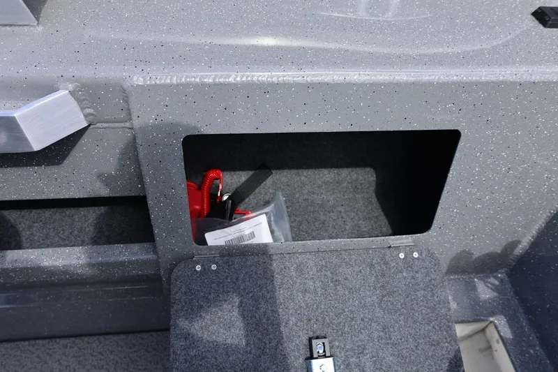 Slide: The Image of Storage compartment in 2026 Thunder Jet 209 Rush OT boat, featuring speckled gray interior. - 39