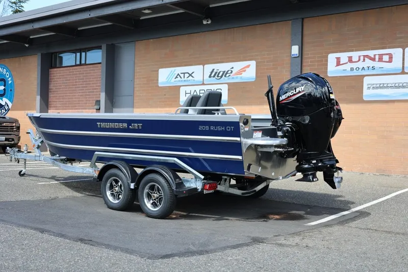Slide: The Image of 2026 Thunder Jet 209 Rush OT boat on trailer, featuring Mercury outboard motor. - 4