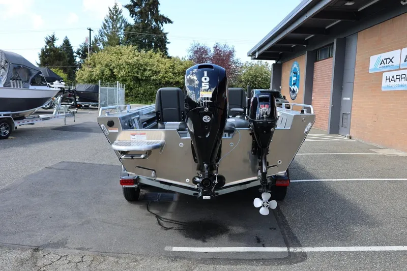 Slide: The Image of 2026 Thunder Jet 209 Rush OT boat with dual outboard motors in a dealership lot. - 5